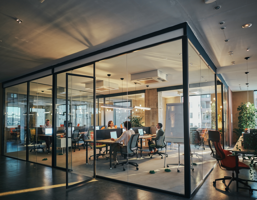 “Group of office professionals gathered around a conference table in a modern meeting room, collaborating on business strategies, sharing ideas, and discussing project plans in a corporate environment