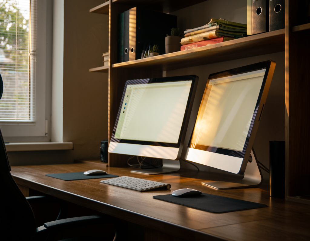 Clean desk with laptop, passport, and organized documents.